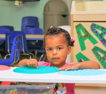 Little one at the sensory activity table